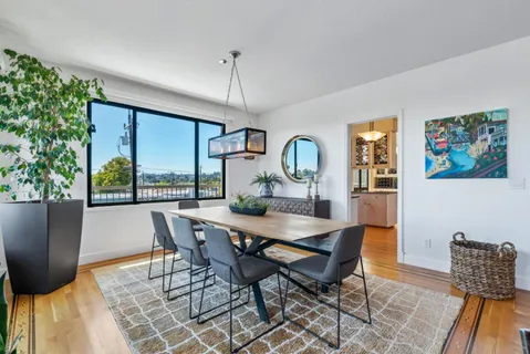 a view of a dining room with furniture window and wooden floor