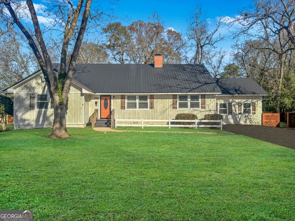a front view of a house with a garden