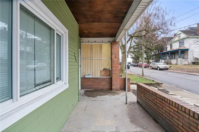 an aerial view of a house with a yard garage and city view