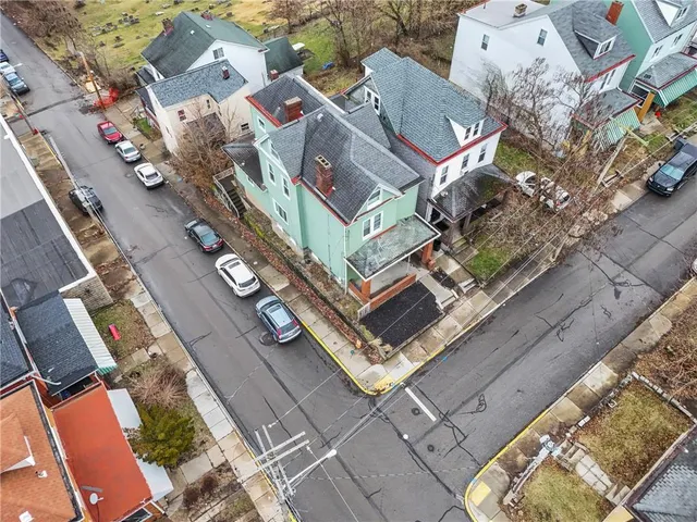 an aerial view of residential houses with outdoor space