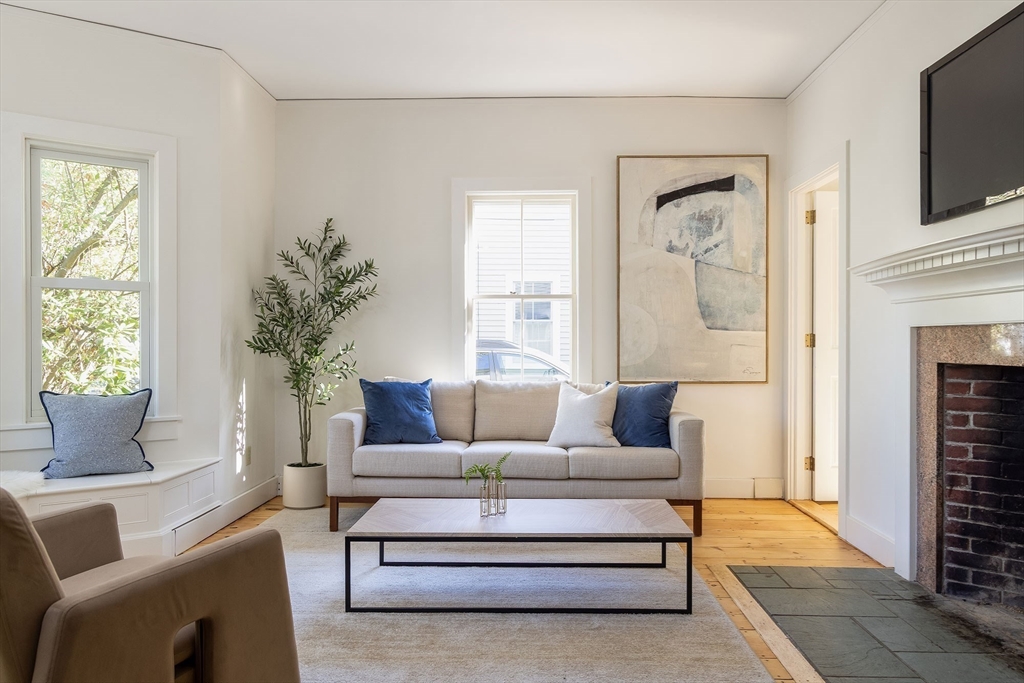 855 Barretts Mill Road Concord, MA 01742 - Photo 2 of 15 a living room with furniture a flat screen tv and a fireplace