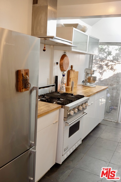 8521 Ridpath Drive Los Angeles, CA 90046 - Photo 6 of 14 a kitchen with stainless steel appliances granite countertop a stove and a sink