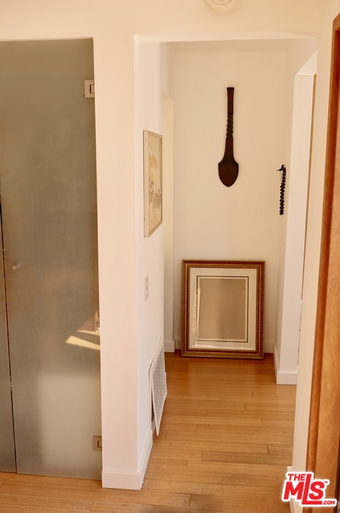 8521 Ridpath Drive Los Angeles, CA 90046 - Photo 9 of 14 a view of a hallway with wooden floor