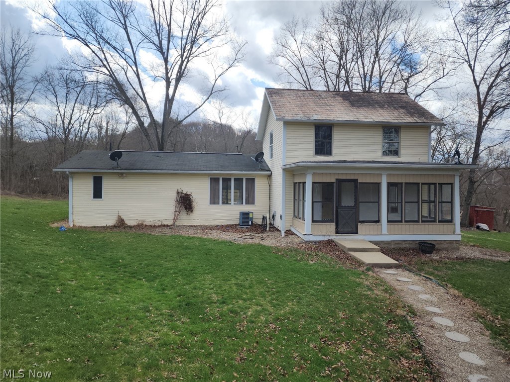 6784 Old Zoarville Road Northeast Dover, OH 44622 - Photo 2 of 50 View of front of property with a sunroom and a front yard