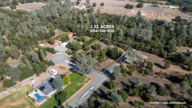an aerial view of a house with a yard and lake view