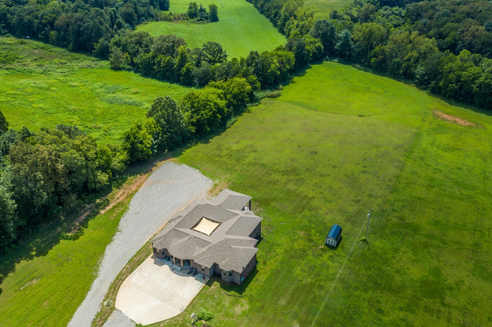 an aerial view of a house with a yard