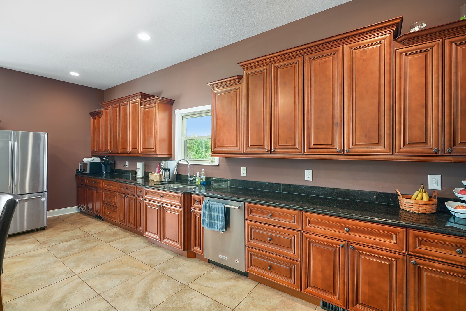 4785 Pulliam-Hardaway Road Springfield, TN 37172 - Photo 23 of 45 a kitchen with stainless steel appliances granite countertop a refrigerator and wooden cabinets