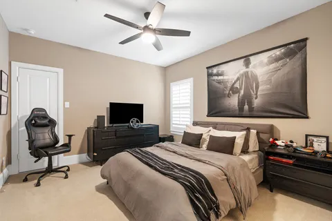 a bedroom with a bed and a painting on the wall