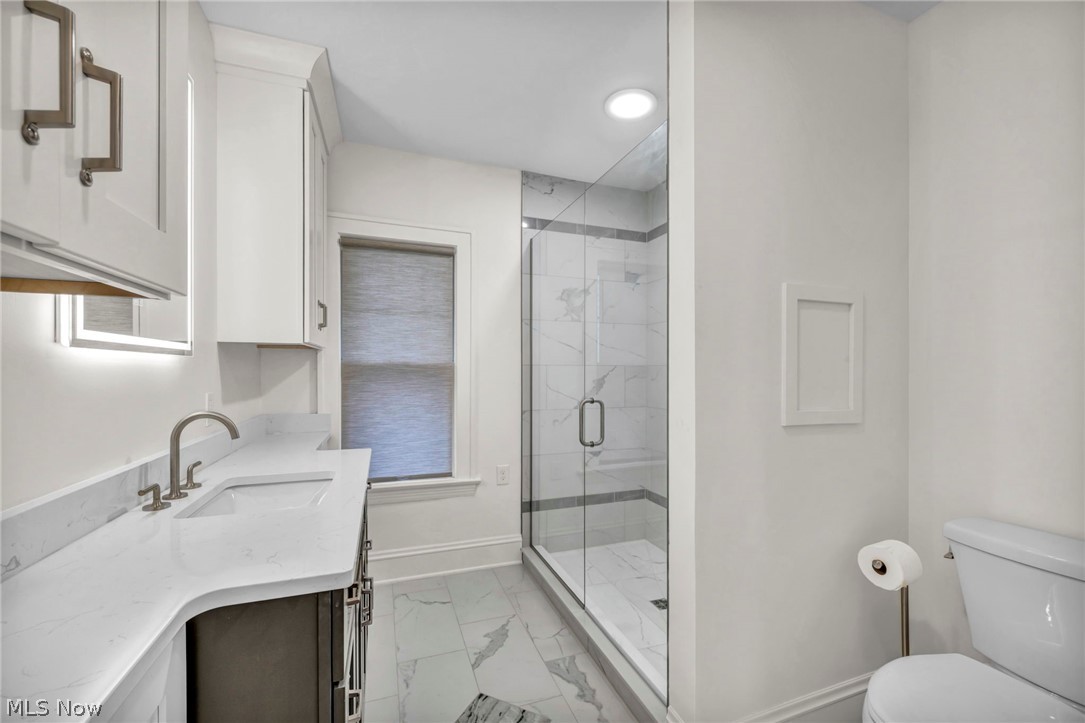 2135 Coventry Road, Unit DOWN Cleveland, OH 44118 - Photo 25 of 34 Full bathroom featuring light marble finish floors, vanity, a marble finish shower, and recessed lighting