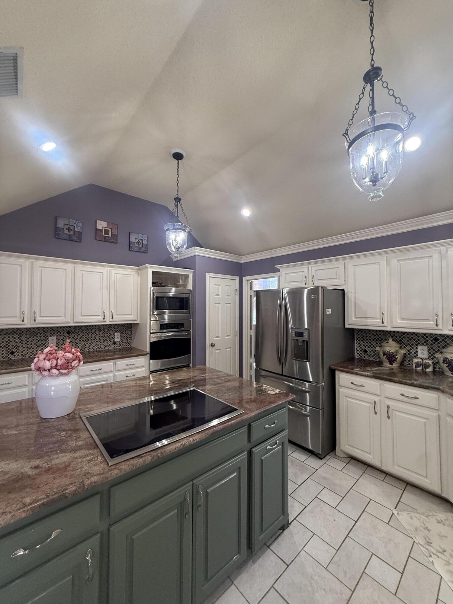 4810 99th Street Lubbock, TX 79424 - Photo 12 of 48 a kitchen with stainless steel appliances granite countertop a sink refrigerator and microwave