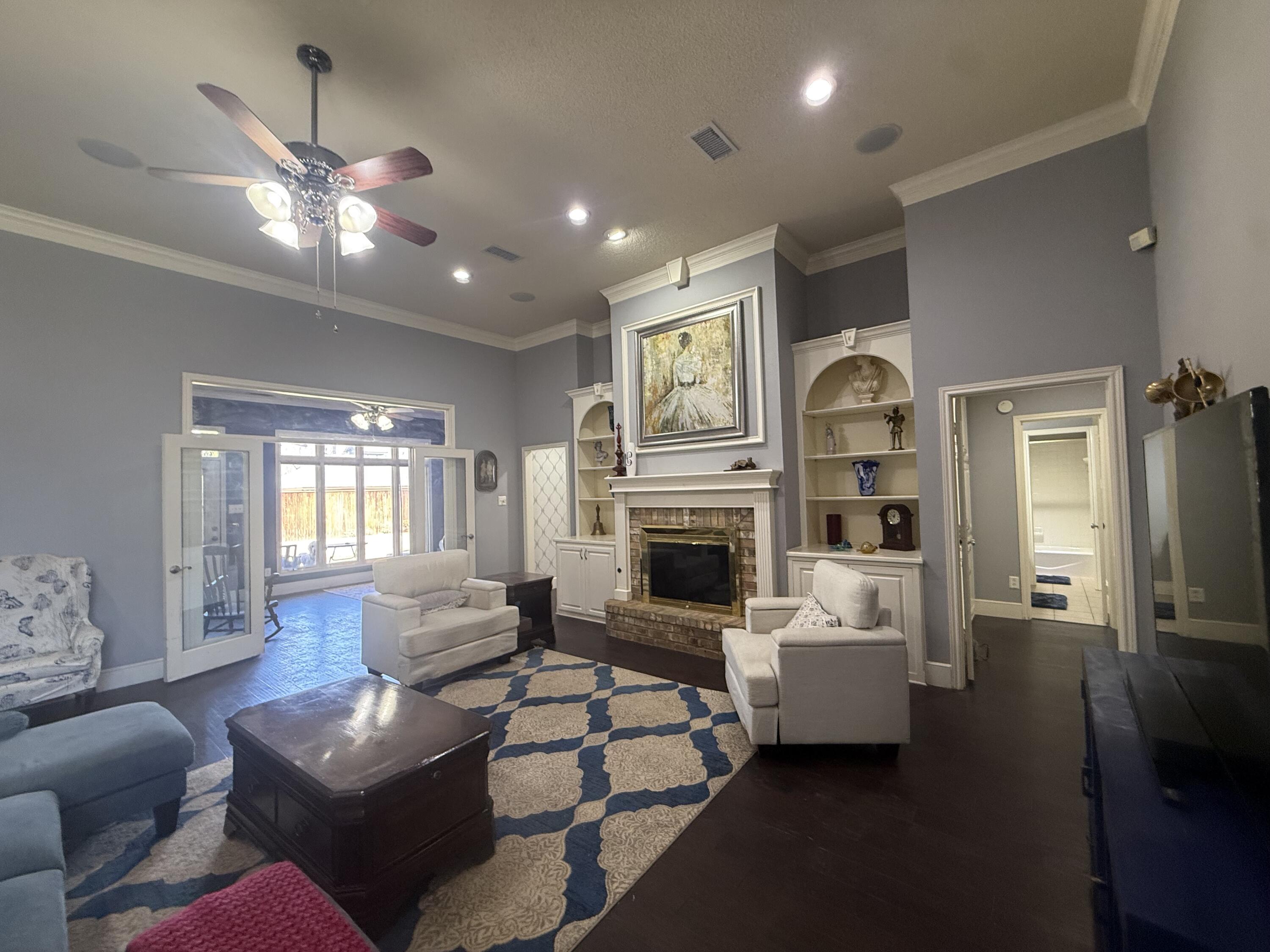 4810 99th Street Lubbock, TX 79424 - Photo 3 of 48 a living room with furniture and a fireplace