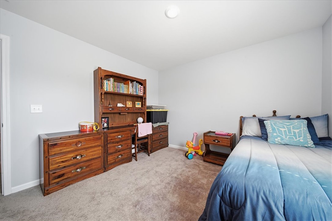 208 Grassy Creek Way Pendleton, SC 29670 - Photo 25 of 43 A well-lit bedroom features plush carpeting, creating a comfortable living space.
