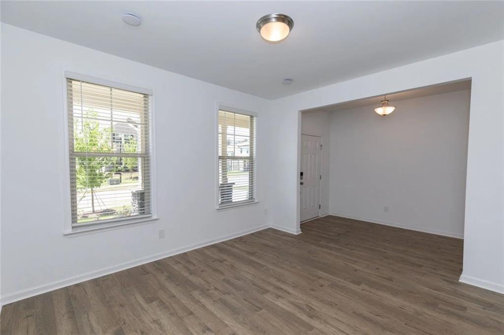 2159 Derrick Drive Grayson, GA 30017 - Photo 2 of 8 an empty room with wooden floor and windows