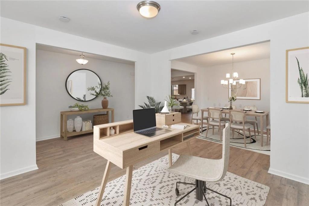 2159 Derrick Drive Grayson, GA 30017 - Photo 6 of 8 a living room with furniture a mirror and wooden floor
