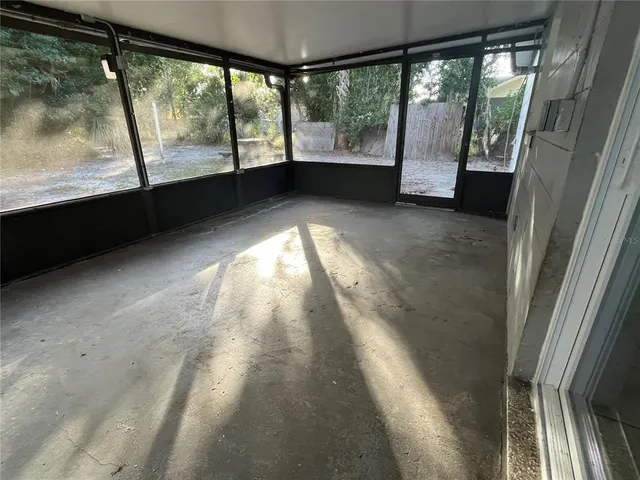 a view of empty room with large windows
