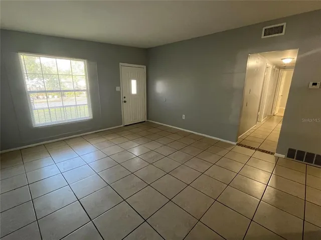 a view of an empty room and a window