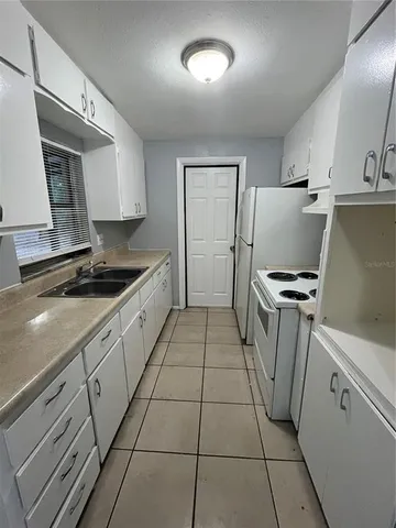 a kitchen with a refrigerator a stove a washer and dryer