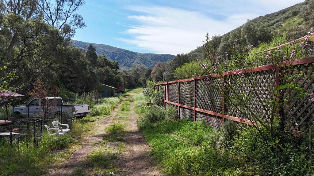 9237 Harmony Grove Road Escondido, CA 92029 - Photo 15 of 56 a view of a backyard with a small garden