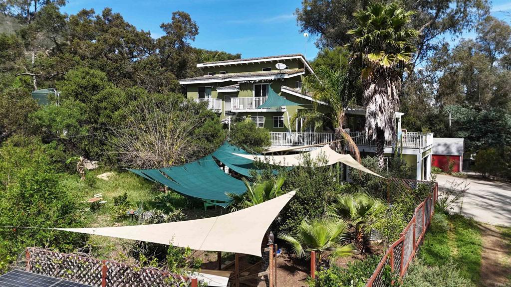 9237 Harmony Grove Road Escondido, CA 92029 - Photo 22 of 56 a view of a patio with table and chairs and potted plants