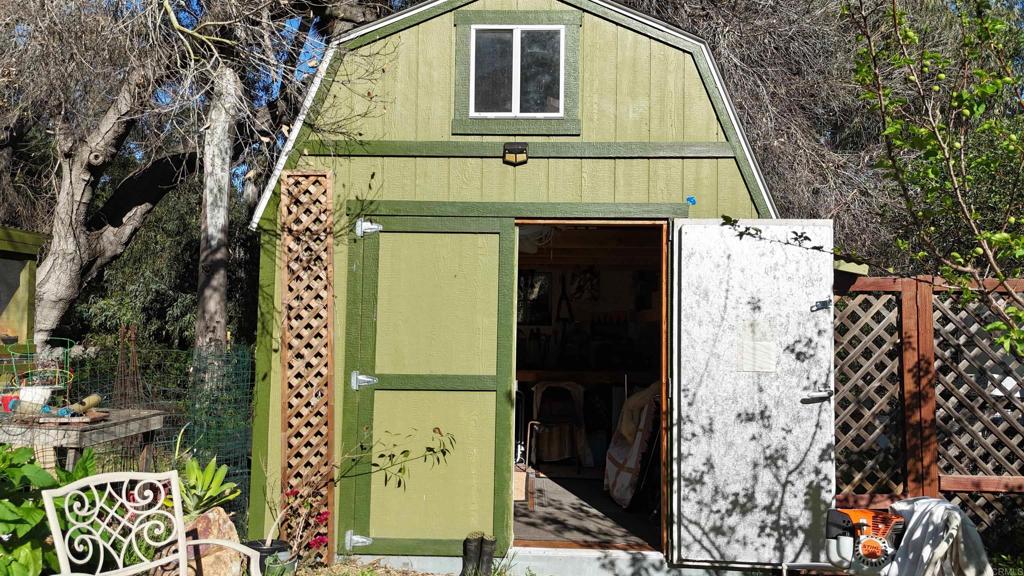 9237 Harmony Grove Road Escondido, CA 92029 - Photo 37 of 56 a front view of a house with a garden