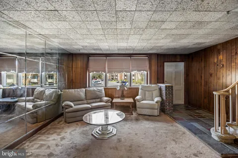a living room with furniture a couch and large window