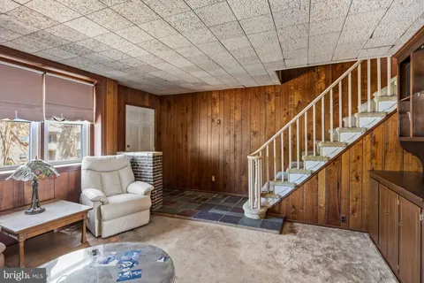 a living room with furniture and stairs