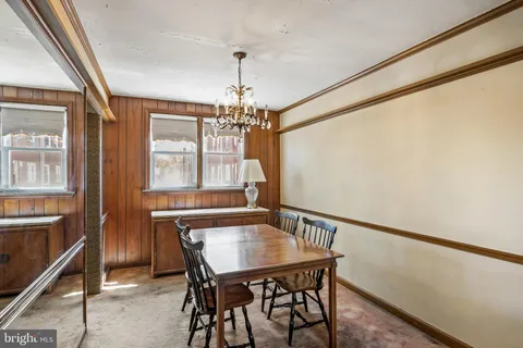 a view of a dining room with furniture and window