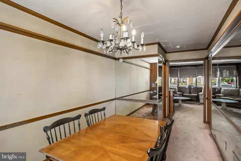 a view of a dining room with furniture and a chandelier