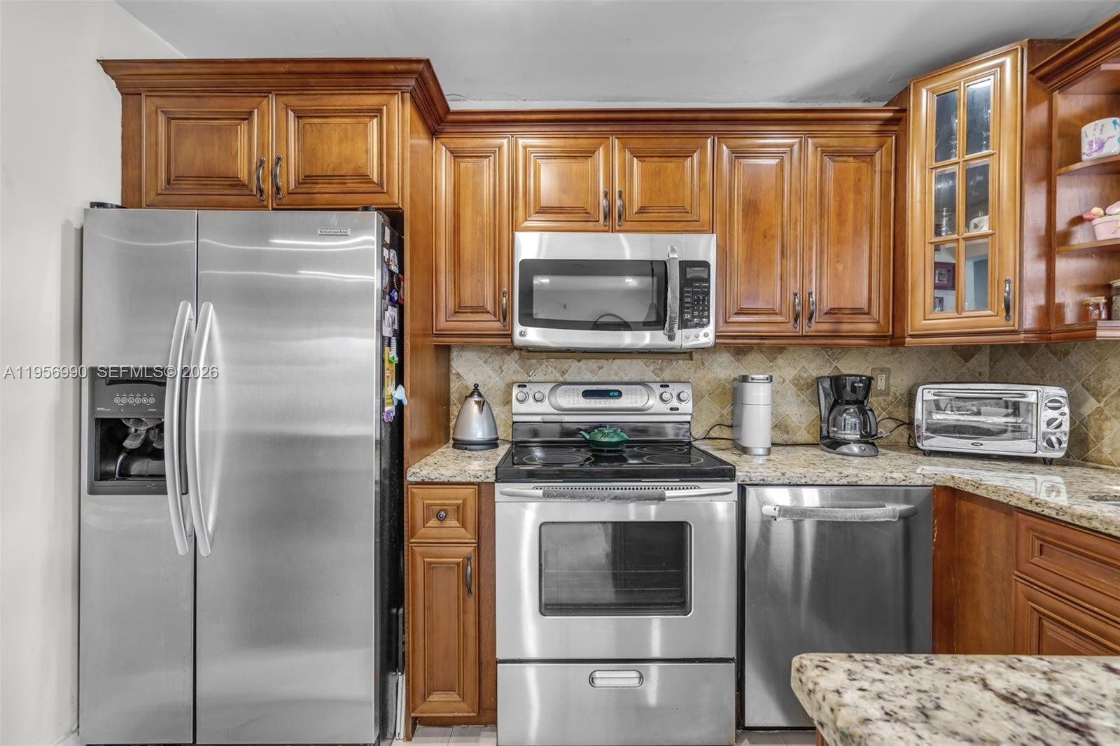 9466 Southwest 6th Lane Miami, FL 33174 - Photo 12 of 34 a kitchen with stainless steel appliances granite countertop a refrigerator a stove a sink and dishwasher