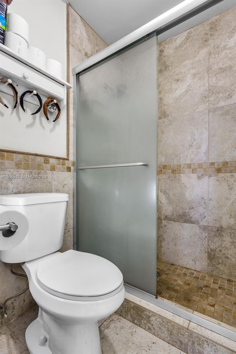 9466 Southwest 6th Lane Miami, FL 33174 - Photo 18 of 34 a bathroom with a toilet and a shower