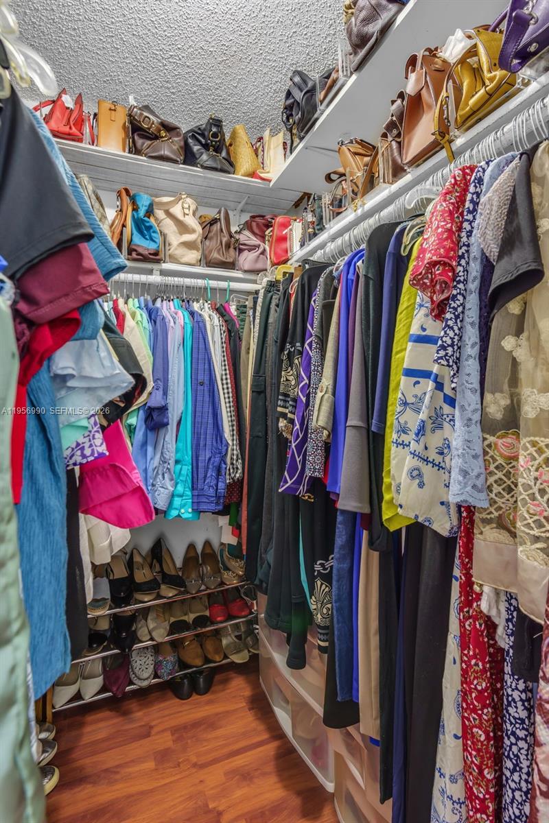 9466 Southwest 6th Lane Miami, FL 33174 - Photo 19 of 34 a view of walk in closet with clothes and shoes