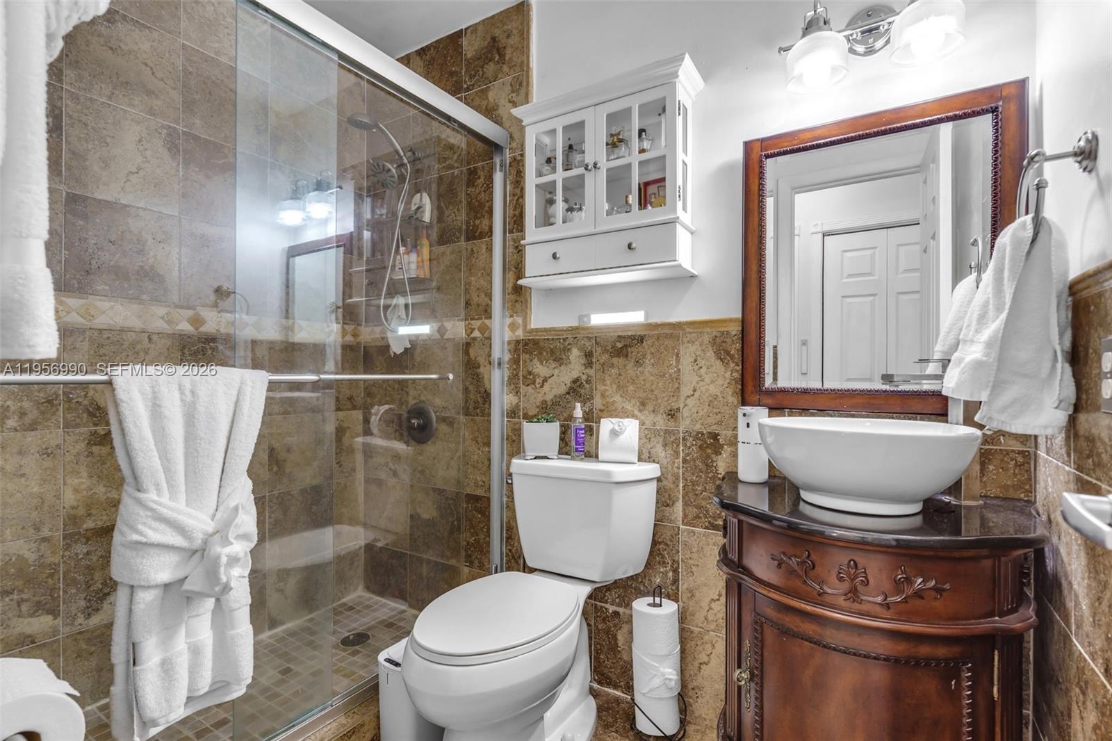 9466 Southwest 6th Lane Miami, FL 33174 - Photo 22 of 34 a bathroom with a toilet a sink and a shower