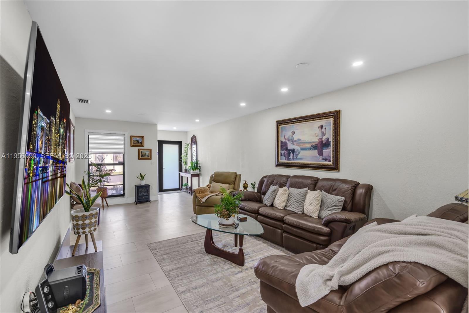 9466 Southwest 6th Lane Miami, FL 33174 - Photo 6 of 34 a living room with furniture and a flat screen tv