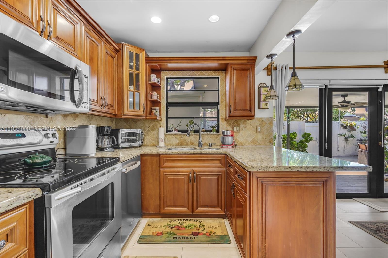 9466 Southwest 6th Lane Miami, FL 33174 - Photo 10 of 34 a kitchen with stainless steel appliances granite countertop a stove a sink and a microwave