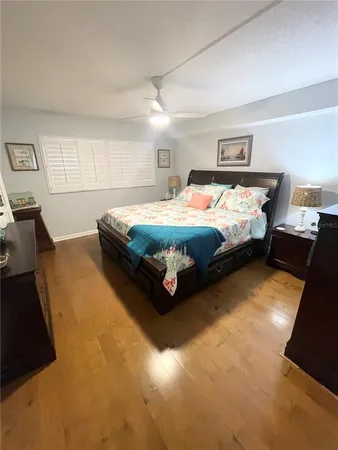 a bed sitting in a room next to a lamp