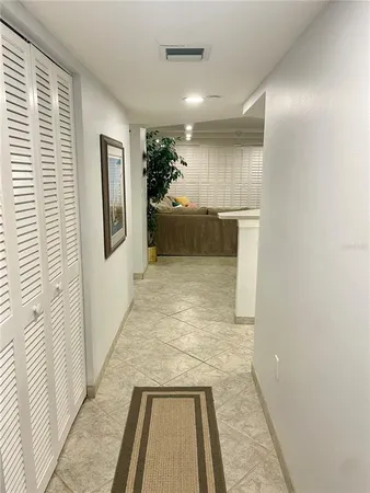 a view of a hallway with a couch and a window