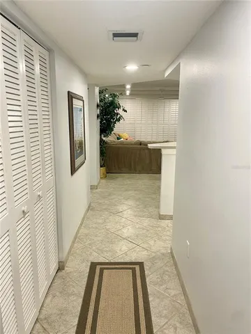 a view of a hallway with a couch and a window