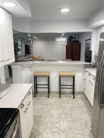 a kitchen with granite countertop a sink and cabinets