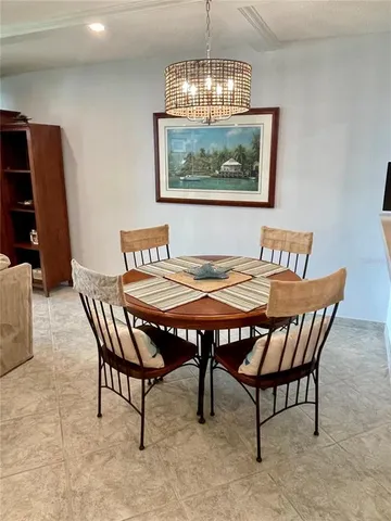 a view of a dining room with furniture a chandelier and wooden floor