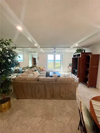 a living room with furniture a dining table and a fireplace