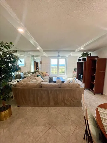 a living room with furniture a dining table and a fireplace