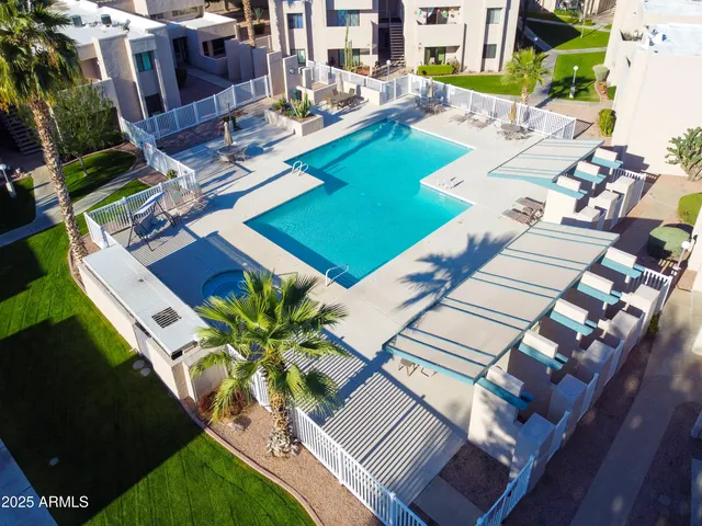 a front view of a house with a yard and a tree