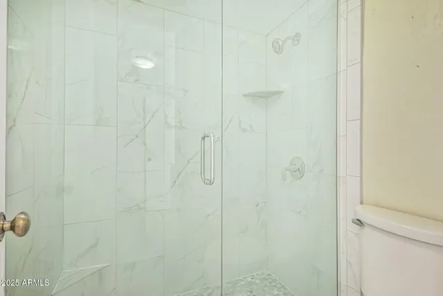 an empty room with a window and a ceiling fan