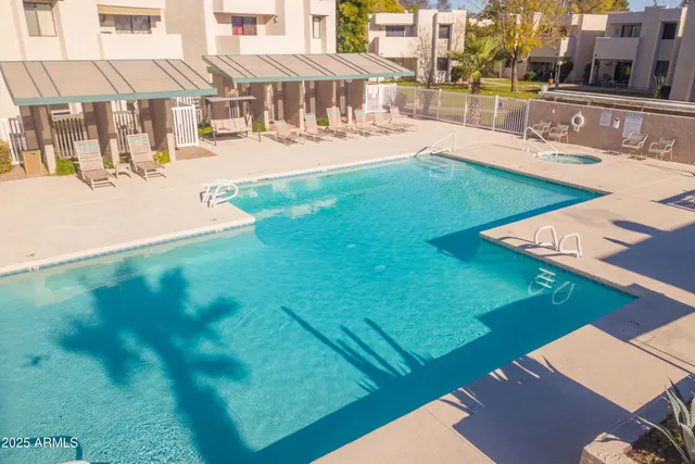 a swimming pool with outdoor seating and yard
