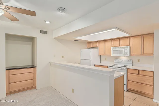 a kitchen with a sink a stove cabinets and a refrigerator