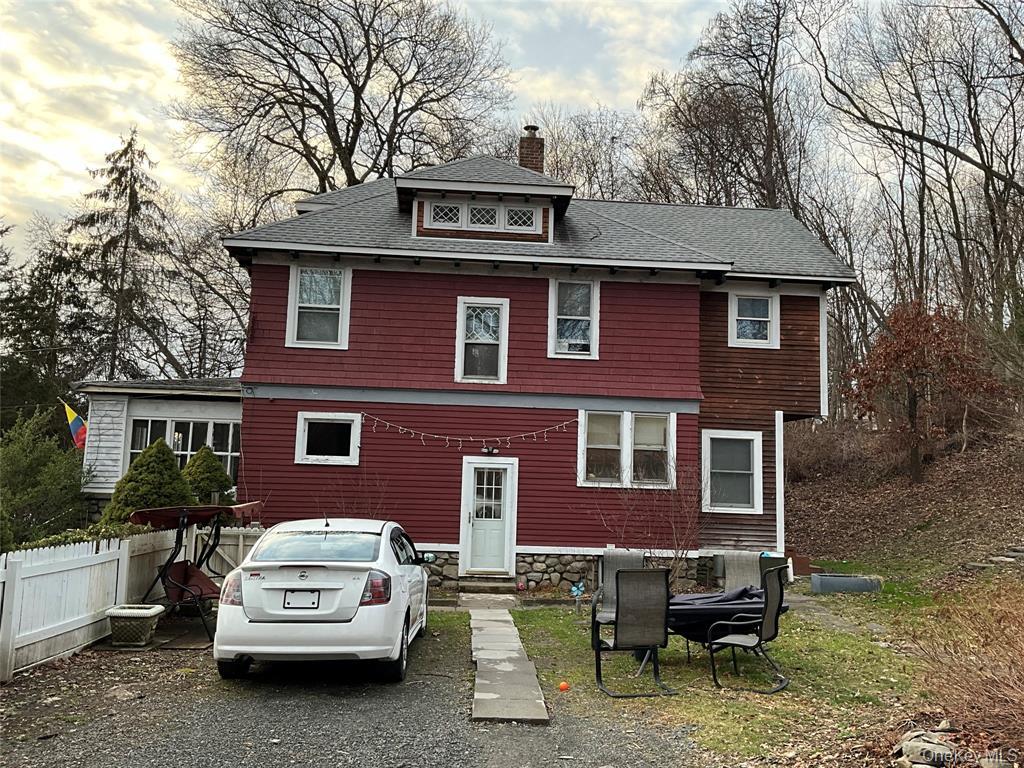 a car parked in front of a brick house