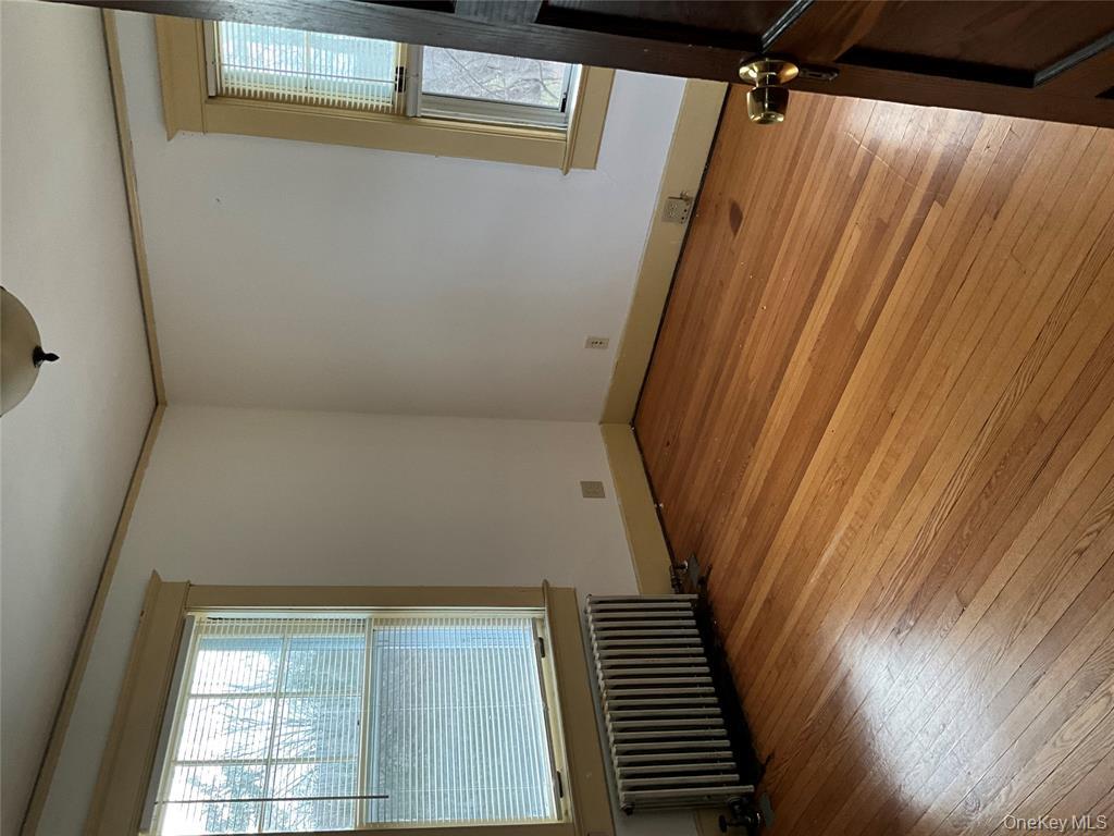 265 Spring Street Monroe, NY 10950 - Photo 11 of 20 an empty room with wooden floor and windows