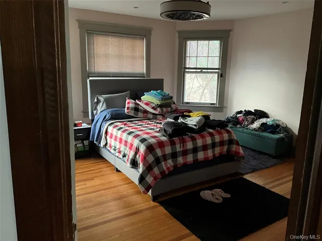 a bed sitting in a bedroom next to a window