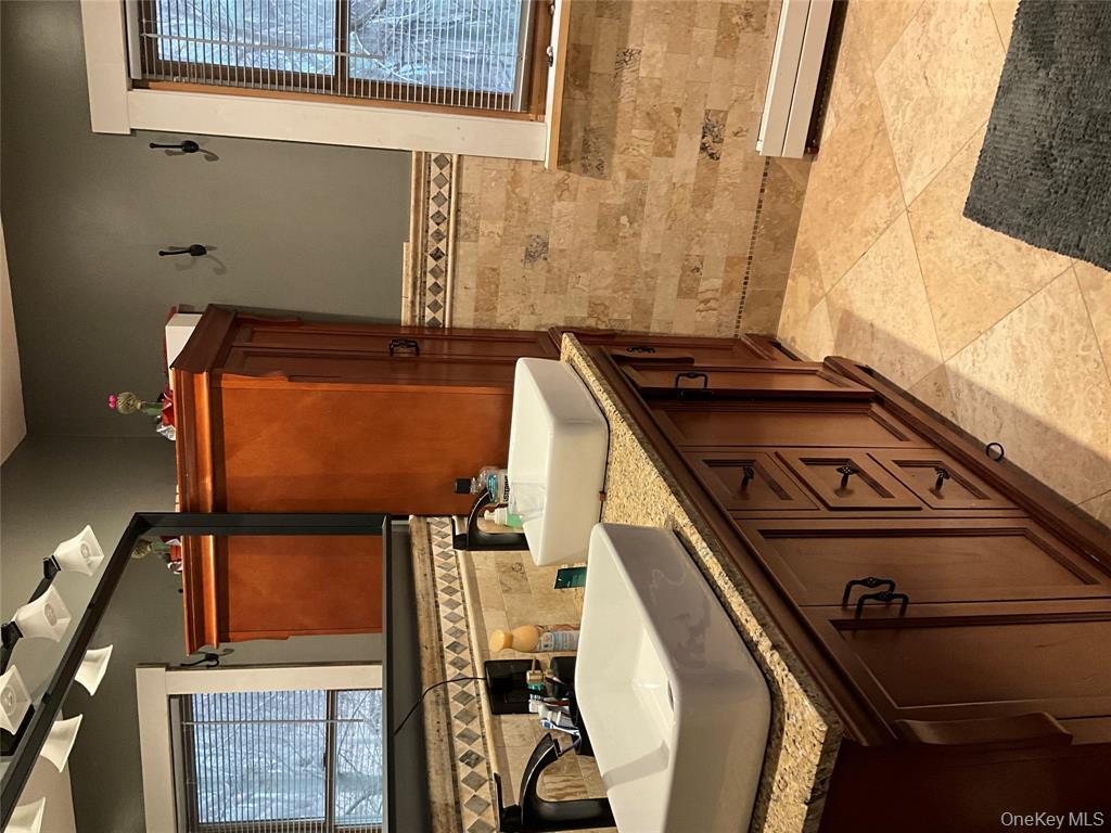 265 Spring Street Monroe, NY 10950 - Photo 15 of 20 a bathroom with a sink and a mirror