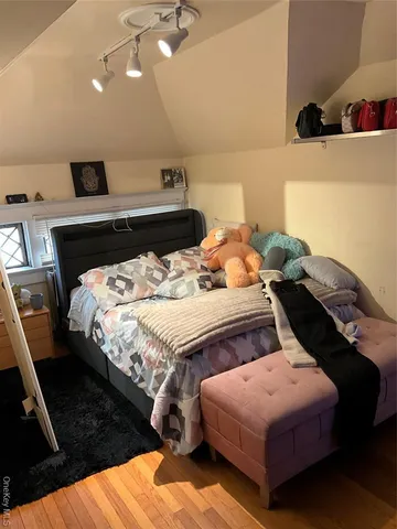 a bedroom with a bed and a dresser